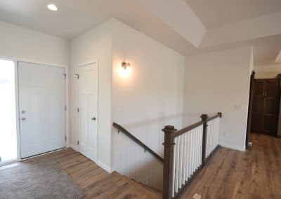View of main entry and stair leading to basement