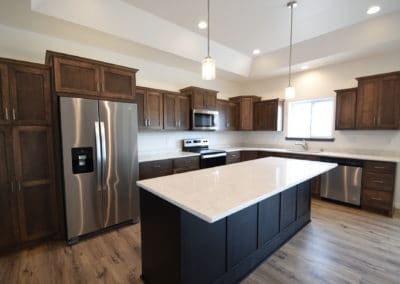 View of kitchen island, kitchen, cabinets, and countertops