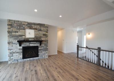 View of living space with gas fireplace with wood floors