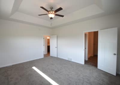 View of master bedroom with vaulted ceiling with fan
