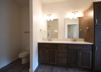 View of bathroom with dual vanity and cabinets