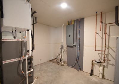View of utility room furnace and electrical panel