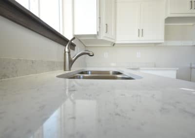 Dual sink with white granite countertop